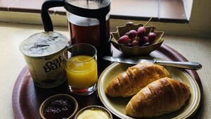 A breakfast tray with a coffee pot, instant oats, juice, croissants, and jams. - Beachborough Park (Folkestone)