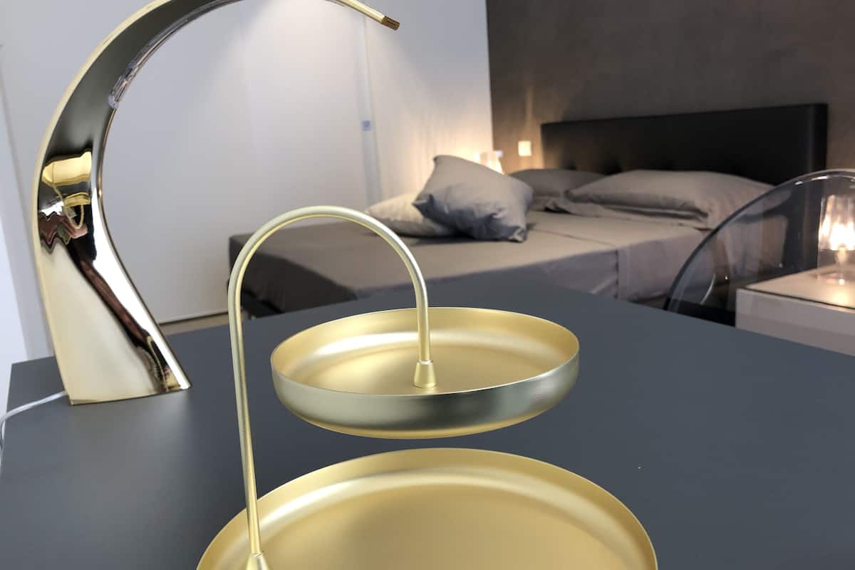 A modern bathroom with a gold faucet and a double basin sink.