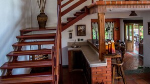 A wooden staircase with a brick wall and a window. - Beautiful Chalet in El Caimo (El Caimo)