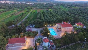 A resort with a swimming pool, multiple villas, and a windmill. - Villa AnnaMaria (Minoa Pediada)