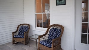 Two wicker chairs with patterned cushions outside a house with a 'Welcome' sign. - Sunny Jenness Beach View Home – Quiet Rd, Perfect for Families & Coastal Escapes (Rye)
