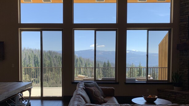 A room with a large sliding glass door leading to a balcony with a mountain view. - The EDGE:  Picturesque & Secluded Gem - Scenic View (Shaver Lake)