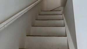A staircase with white walls and a simple design.