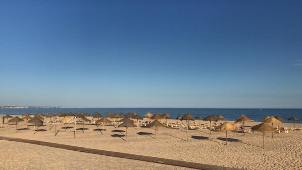 On the beach, sun loungers, beach towels