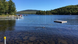 A calm lake with clear water, docks, and boats. - Pond House - Donnell's Pond in Franklin, Maine (Franklin)