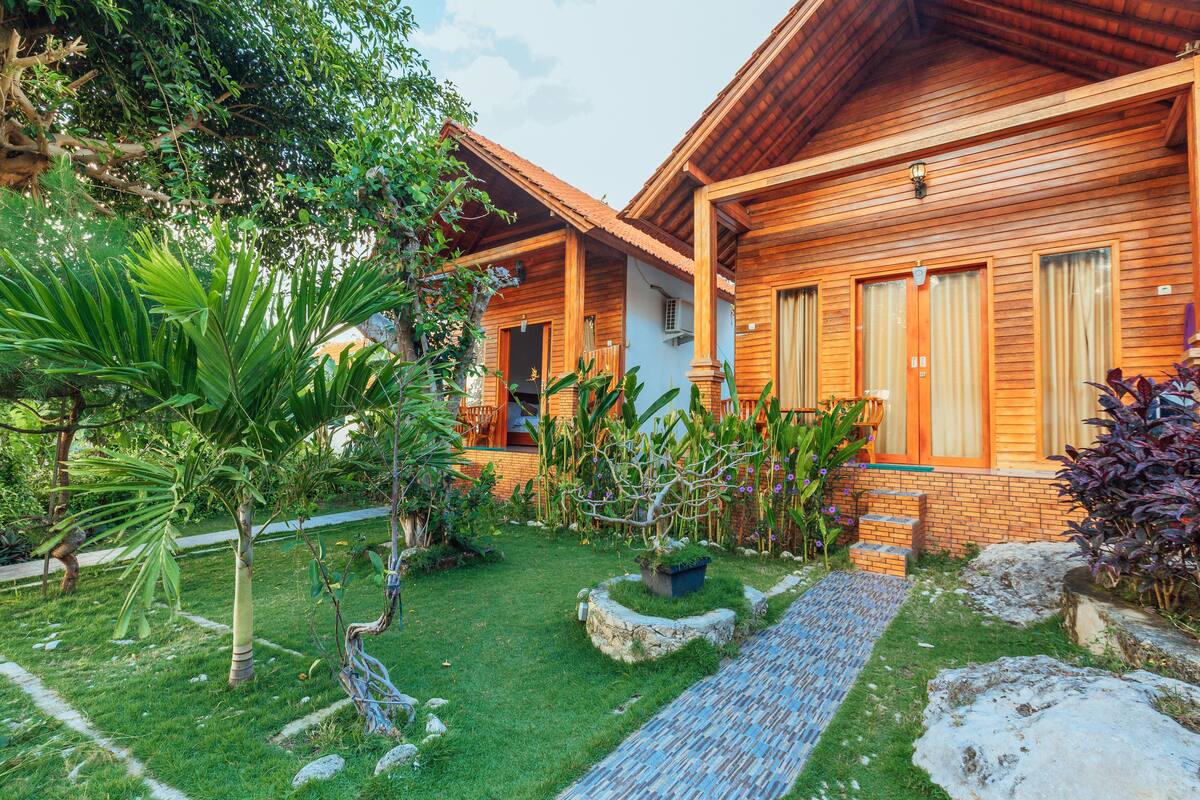 A wooden building with a garden in front.