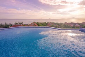 A swimming pool with a clear view of the ocean and distant islands. - Fivitel Hoi An Hotel (Da Nang)
