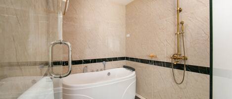 A modern bathroom with a freestanding bathtub, a glass-enclosed shower area, and a marble-tiled floor.