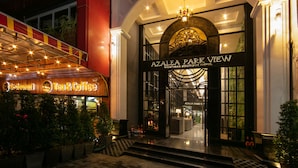 The entrance to Azalea Park View, featuring a grand archway, illuminated signage, and a well-lit facade. - Azalea Parkview Hotel (Vientiane)