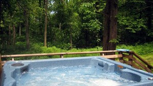 A hot tub in a forested area with a wooden deck. - Bedrooms 2, Bathrooms 1, Sleeps 4 (Front Royal)