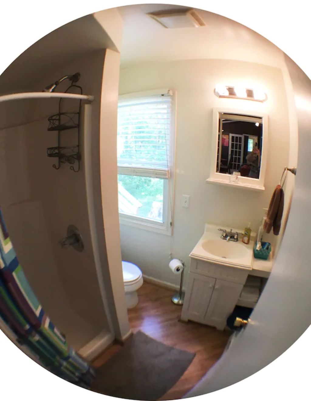 A bathroom with a toilet, sink, and shower.