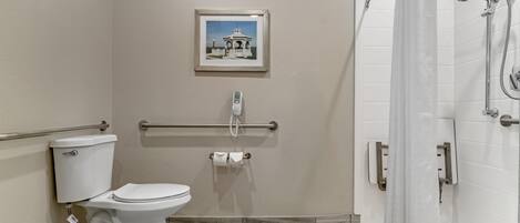 A bathroom with a toilet, bidet, and shower.