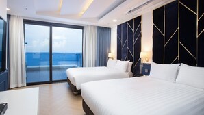 A hotel room with two beds, a large window with curtains, a view of the sea, and a modern design with geometric wall panels. - Utop Marina Hotel & Resort (Yeosu)