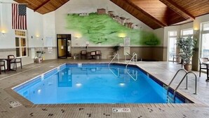An indoor swimming pool with a wooden ceiling, a mural of a landscape, and a flag on the wall. - Unit 411a 1 Bd/ 1 Ba Condo 1 Bedroom Condo by RedAwning (Birchwood)
