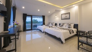 A modern hotel room with two beds, a balcony, a dining area, and a TV. - Hoianation Villas Hotel (Da Nang)