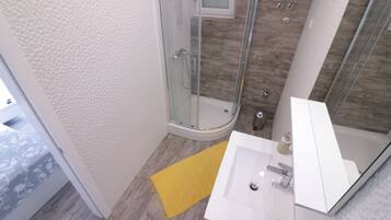 Shower, hair dryer, towels, toilet paper