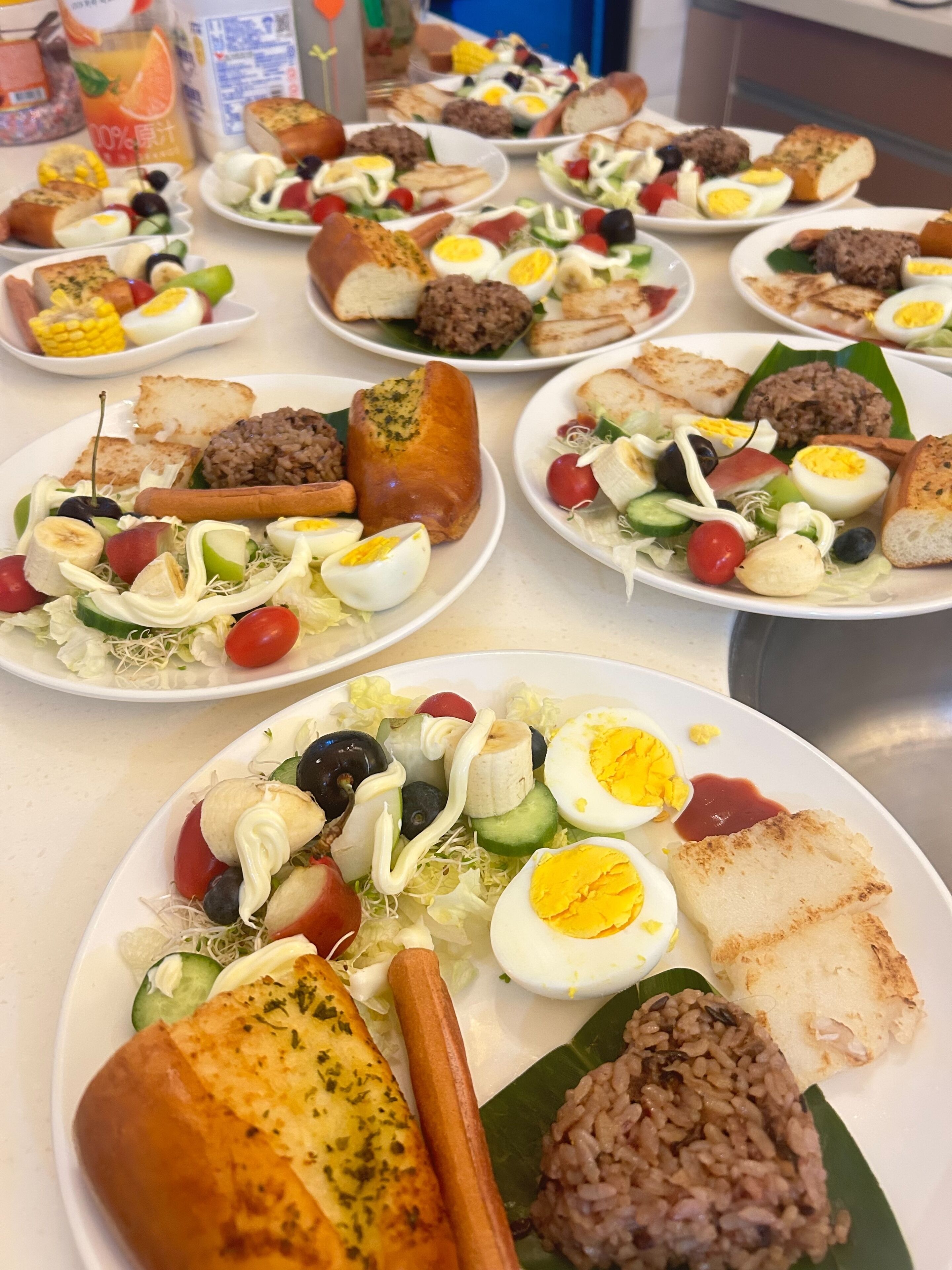 A buffet with various dishes including salads, meats, and rice.