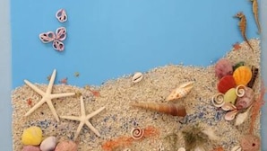 A beach-themed artwork with a blue background, featuring seashells, starfish, and a sandy texture at the bottom. - Shuishang Ya Ju Homestay (Hualien City)
