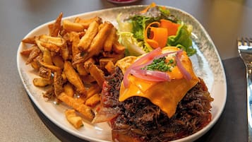 A plate of food with fries, a sandwich, and a salad.