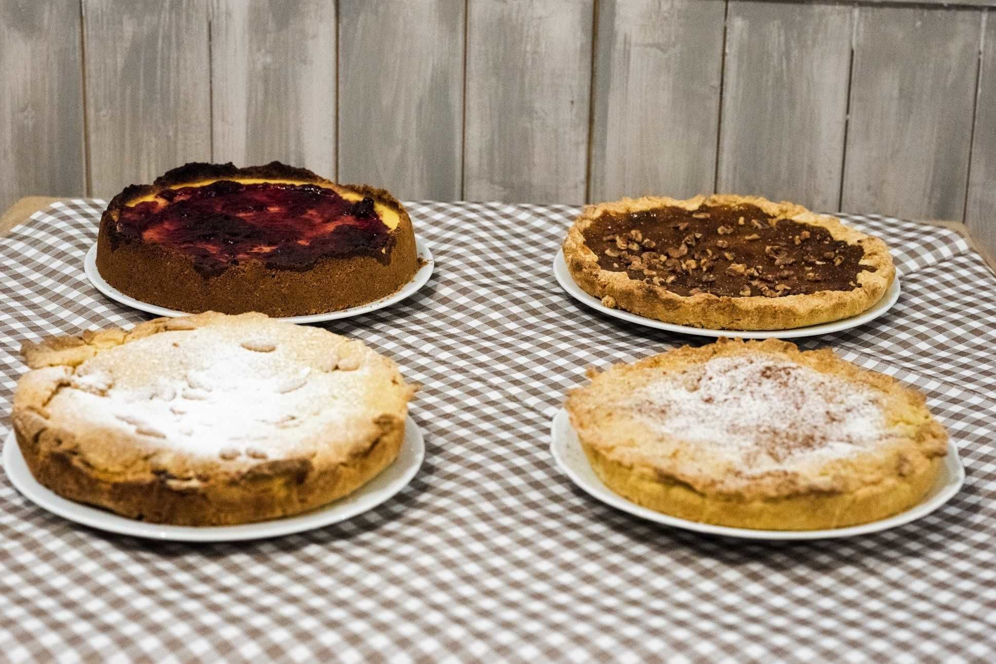Four pies on a checkered tablecloth.