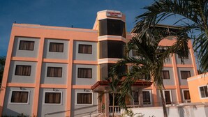A multi-story hotel with a flat facade, multiple windows, and a sign indicating it is the Adamsview Hotel. - Adams View Hotel (Moalboal)