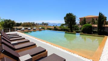Seasonal outdoor pool, open 9:00 AM to 8:00 PM, pool umbrellas