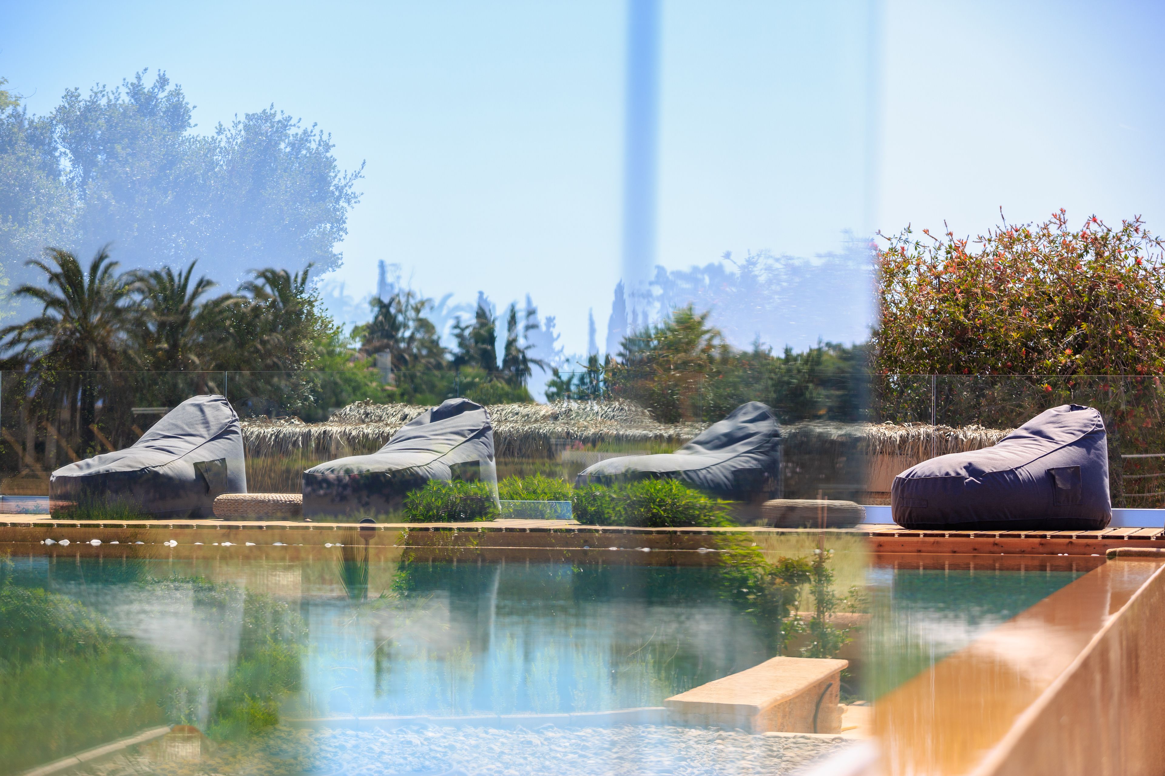 A pool area with lounge chairs and a clear view of a tall structure in the background.