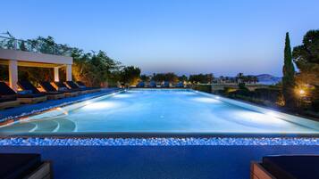 Seasonal outdoor pool, open 9:00 AM to 8:00 PM, pool umbrellas
