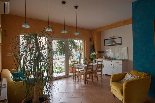 Apartment (Orange) | Living area | 32-inch flat-screen TV with cable channels, Smart TV