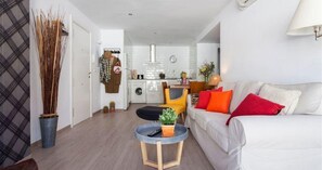 Relax in this stylish living room with a sofa, coffee table, and lush greenery.