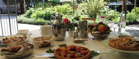 A table set with various dishes and a garden view.