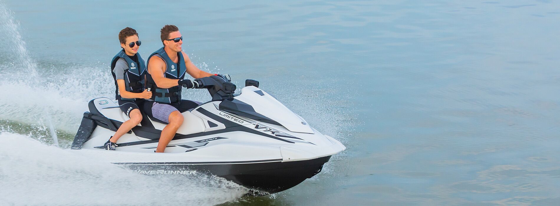 Two people on a Yamaha VXR jet ski.