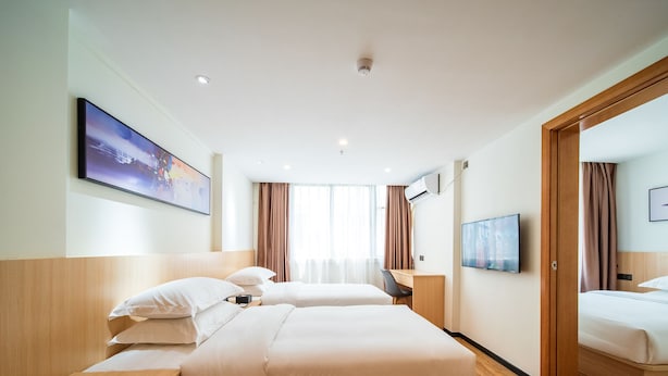 A hotel room with two beds, a desk, a TV, and a window with curtains. - Guangzhou Changxing Xintiandi Hotel (Guangzhou)