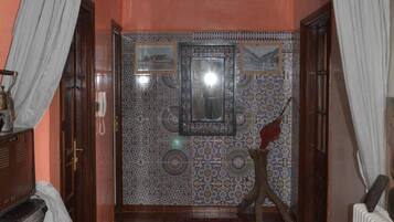 Shower, rainfall showerhead, slippers, towels