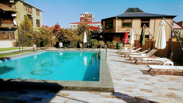 Seasonal outdoor pool, pool umbrellas, pool loungers