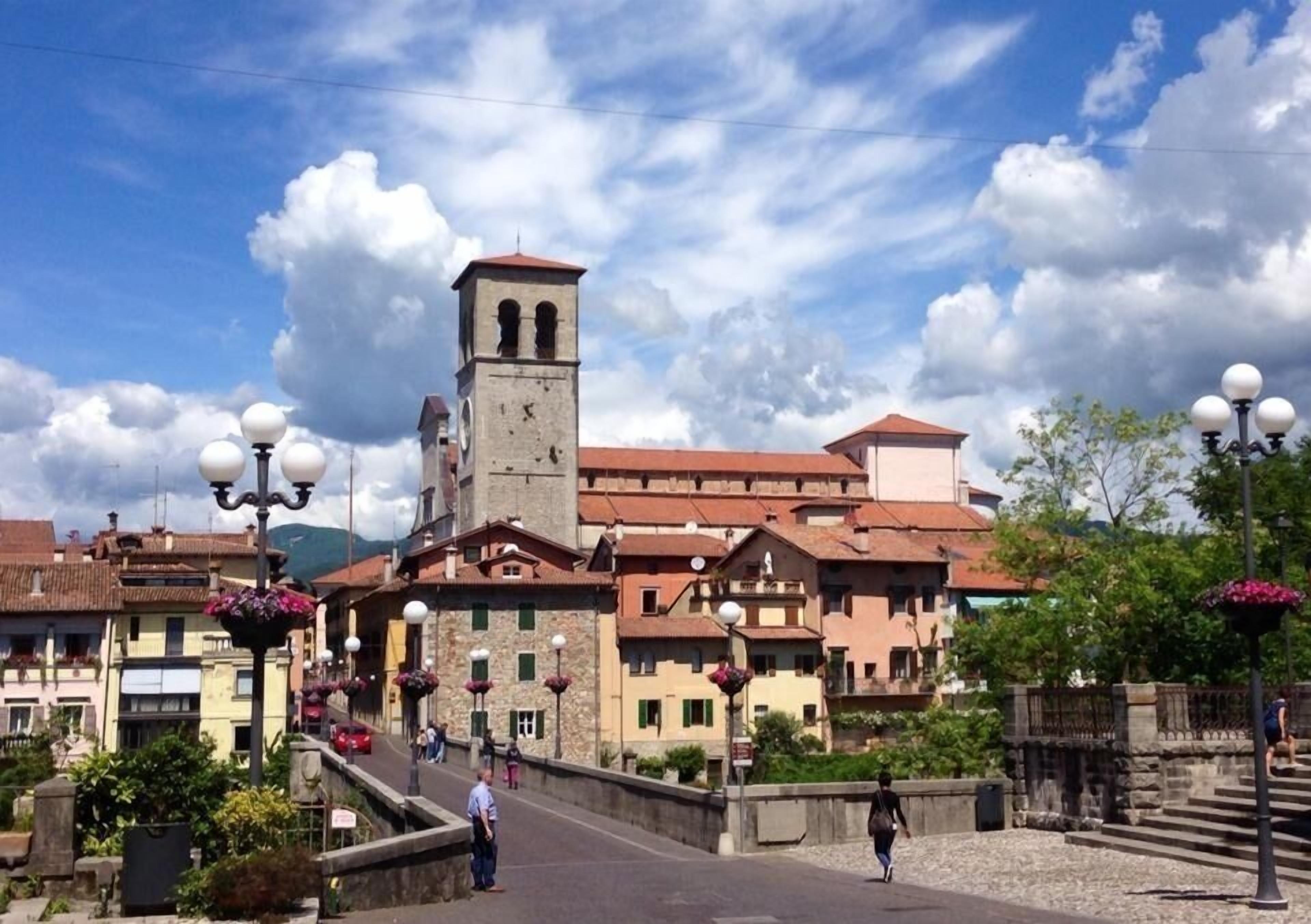A historic town with a prominent clock tower, cobblestone streets, and traditional architecture.