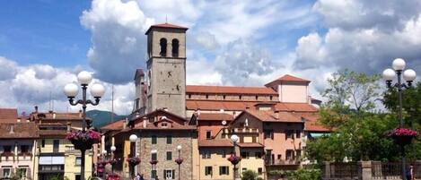 A historic town with a prominent clock tower, cobblestone streets, and traditional architecture.