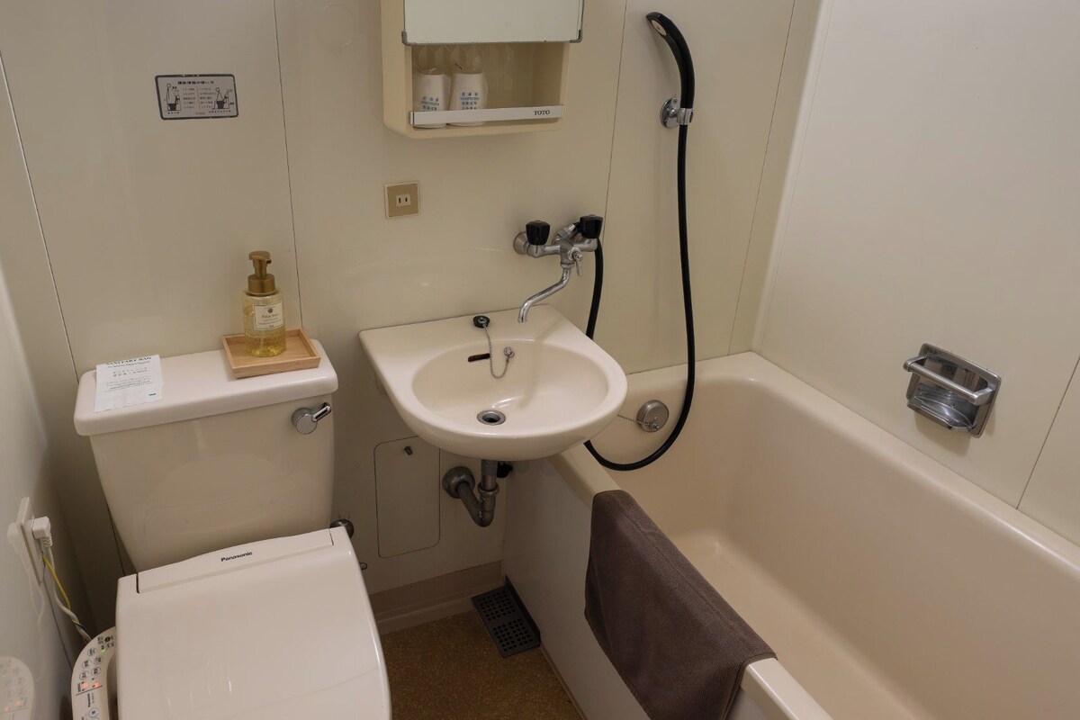 A compact bathroom with a toilet, sink, and bathtub.