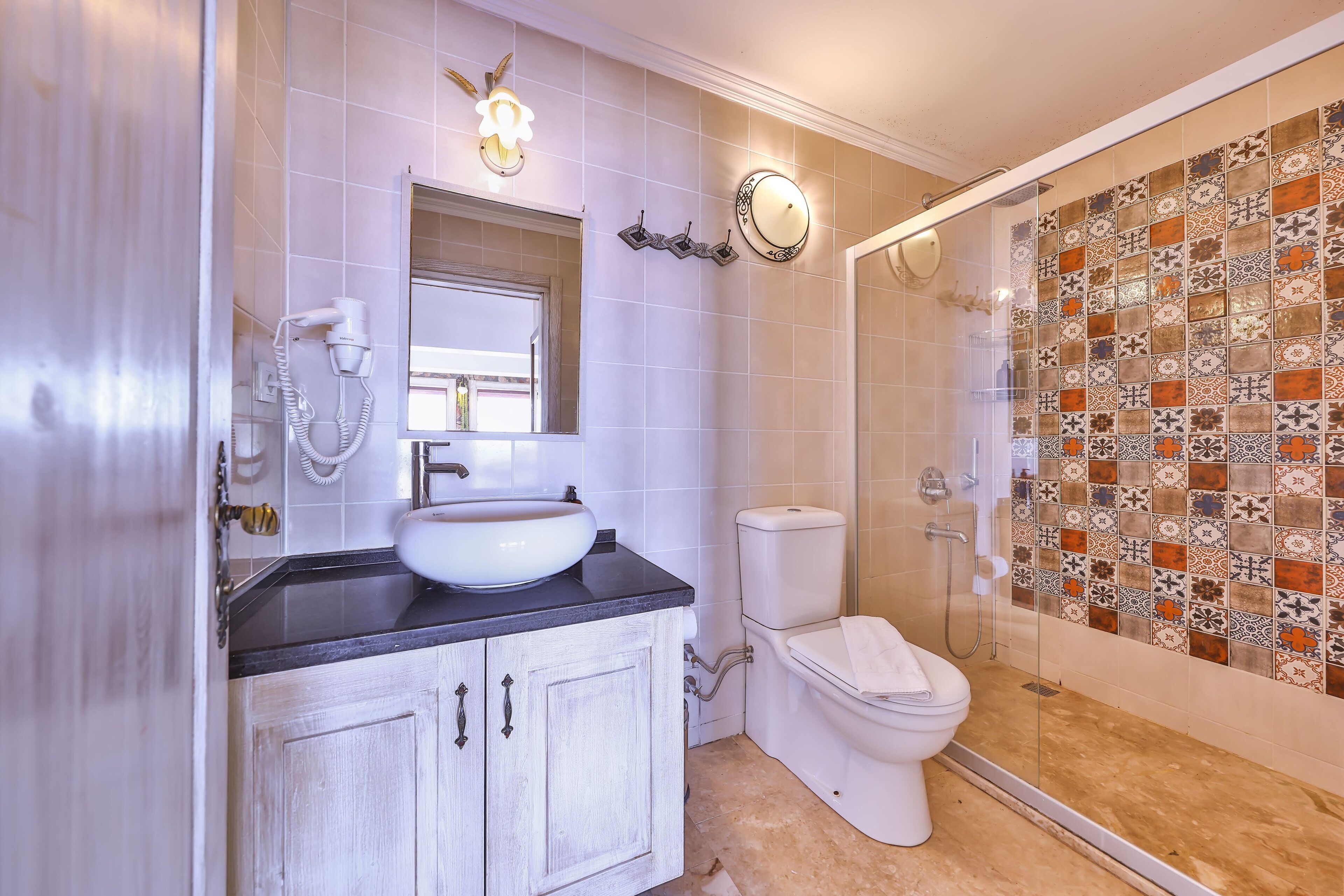 junior suite | bathroom | shower, hair dryer, towels, soap