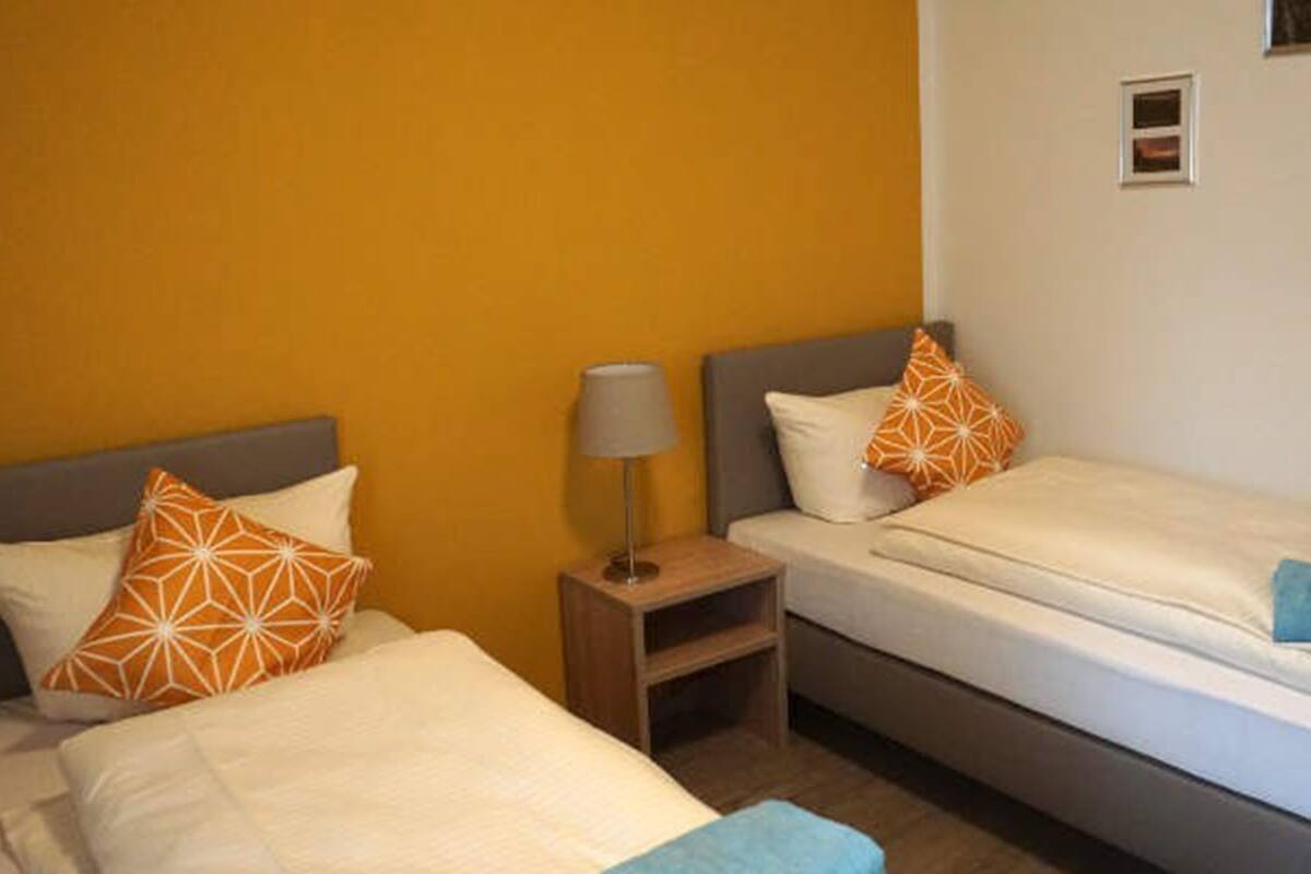 Hypo-allergenic bedding, desk, laptop workspace, blackout curtains