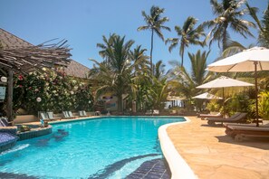 Outdoor pool, pool umbrellas, pool loungers - The Waterfront Zanzibar Beach Hotel (Paje)