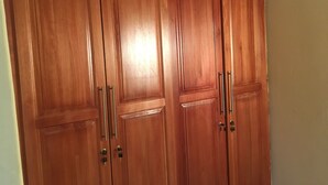 A set of wooden double doors with metal handles and locks. - Beautiful Gates Guest House (Palapye)