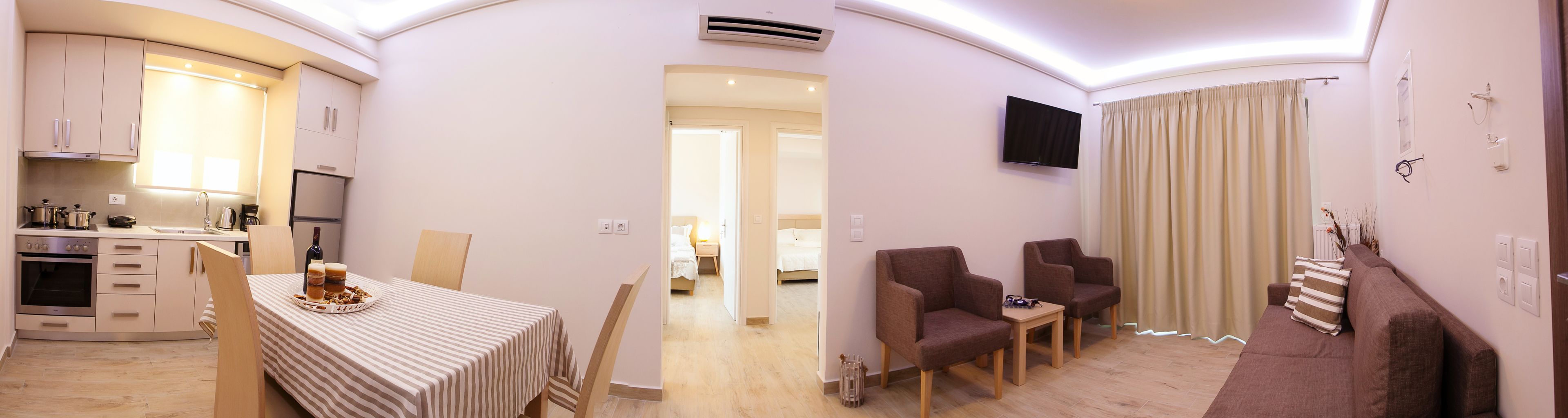 A compact living space with a kitchenette, dining area, and seating area.