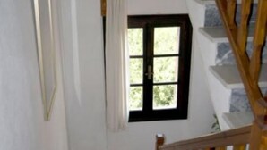 A staircase with wooden railings leading to a landing.