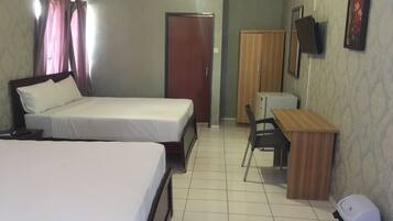 A hotel room with two beds, a desk, a chair, a television, and a wardrobe.