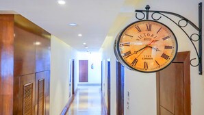 A hallway with a large clock displaying the time and the year 1747. - Ganpati Hotel (Reasi)