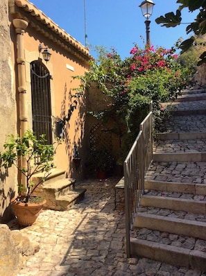 Stroll up the charming cobblestone path to the entrance of this traditional building.