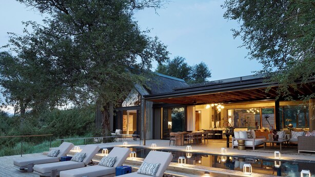 A modern outdoor deck with lounge chairs, a pool, and a dining area.