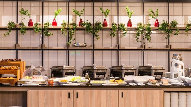 A buffet setup with various food items and a coffee station. - ONOMO Hotel Maputo (Maputo)