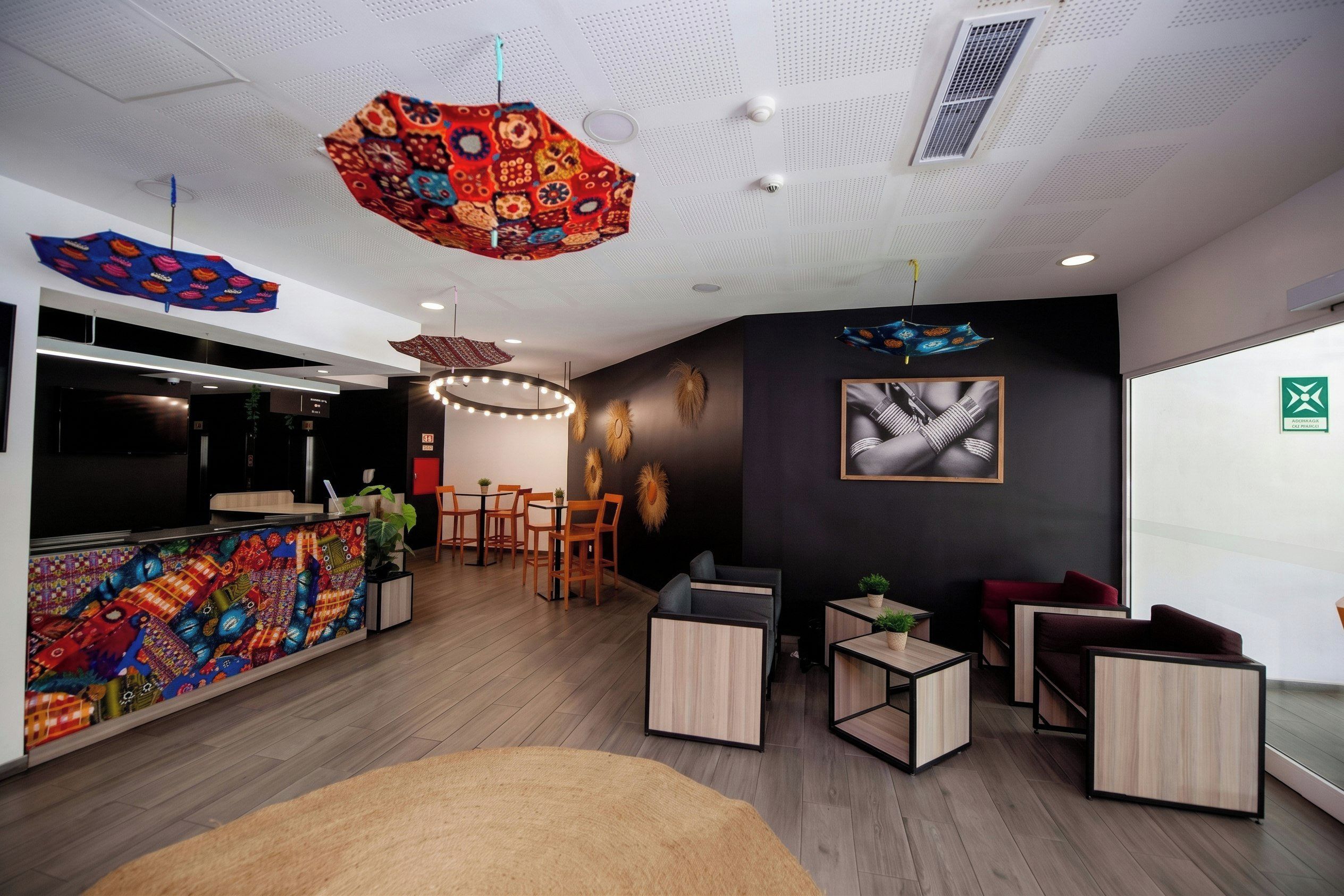 Un interior modern amb taulell de recepció, zona de seients i elements decoratius al sostre.